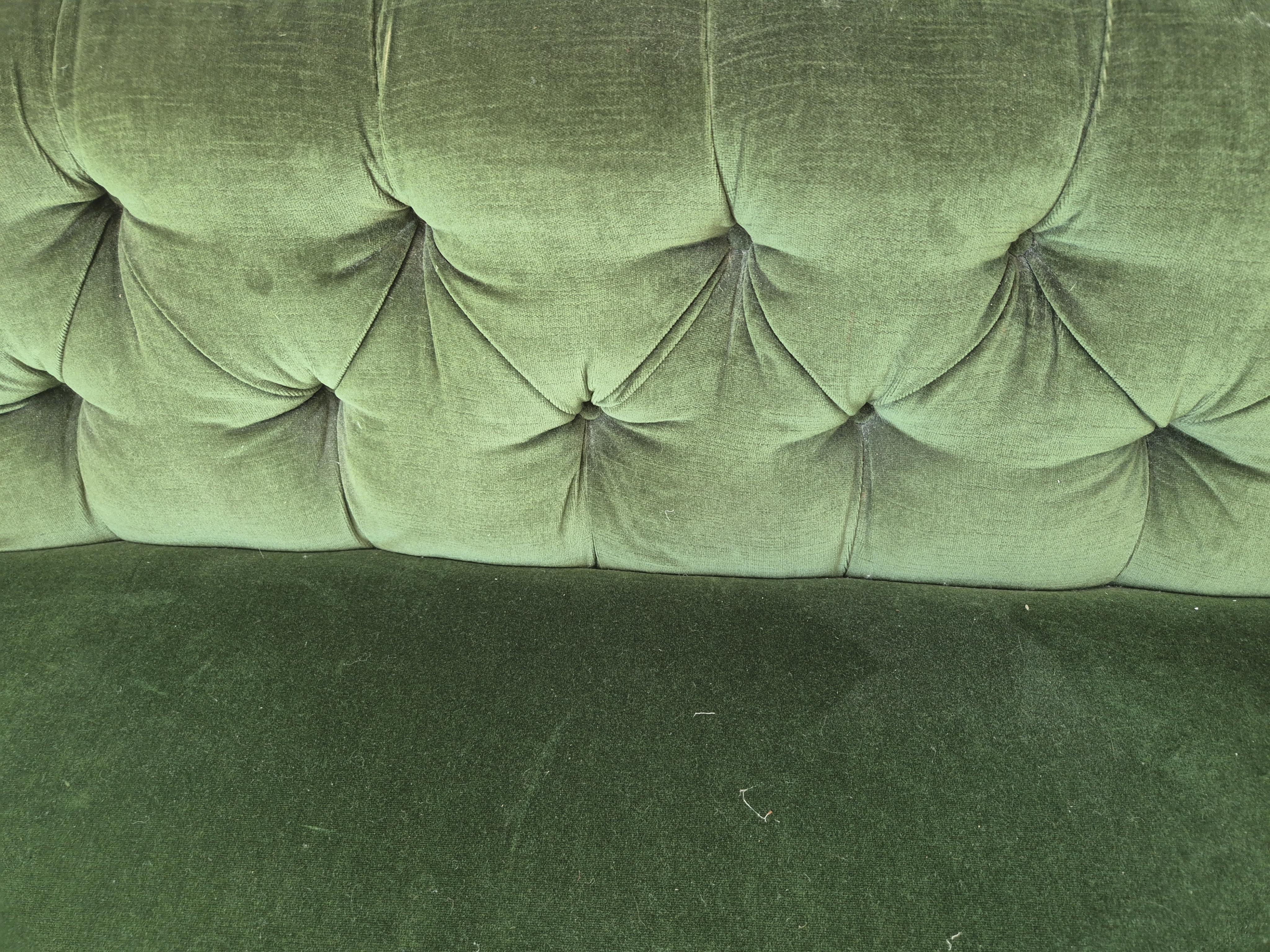 A Victorian mahogany settee upholstered in deep buttoned green velvet, width 210cm, depth 80cm, height 74cm. Condition - fair